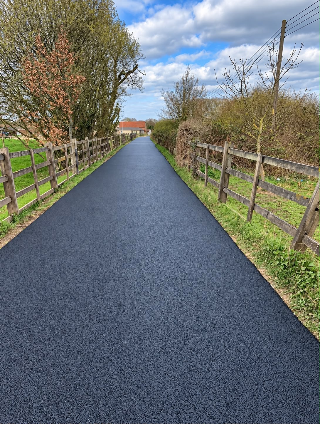 A compacted stone sub-base and kerb edging being prepared before tarmac is laid